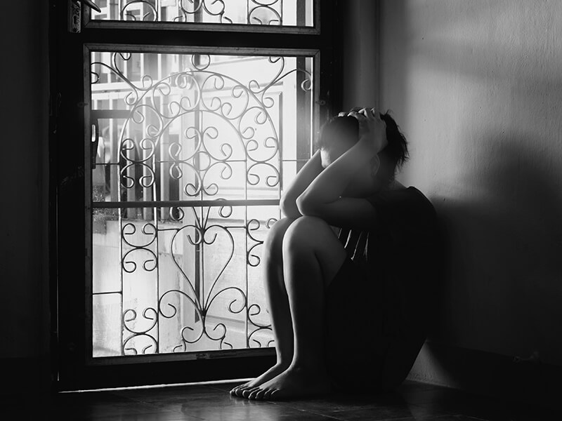 Depression-Sad-Woman-Light-Door_credit-Shutterstock